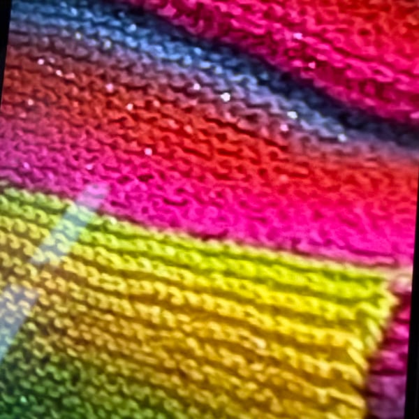 Hand knitted sparkly fringed scarf.