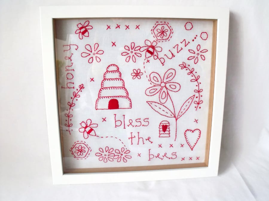 framed red work embroidered bees wall hanging
