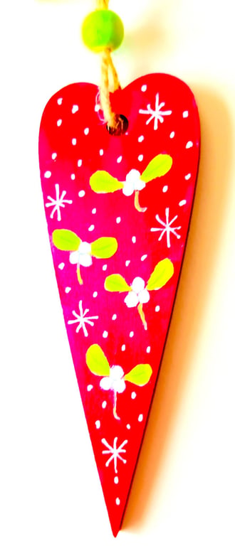 Christmas mistletoe heart decoration on wood