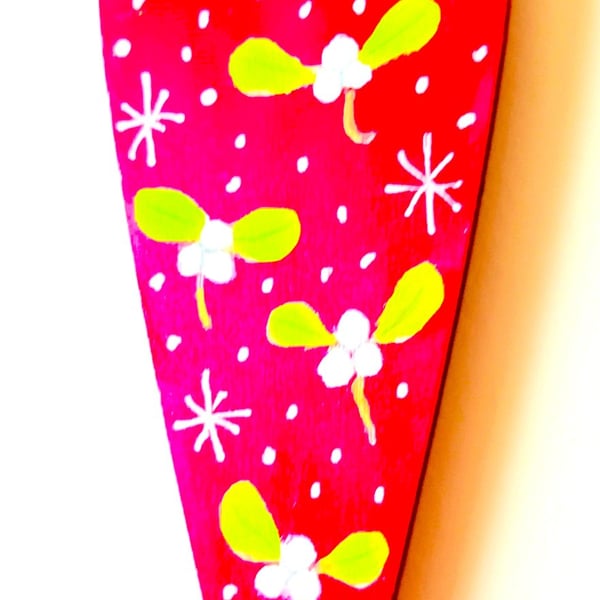 Christmas mistletoe heart decoration on wood
