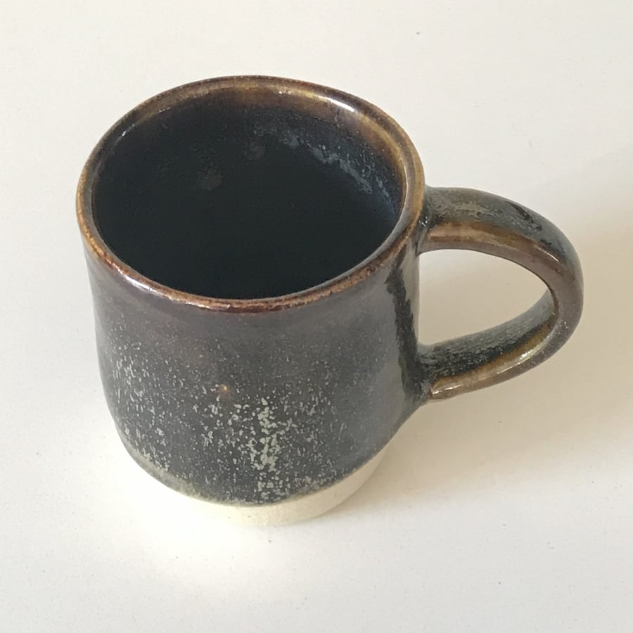 Stoneware pottery mug finished in a combination glaze browns and greys.