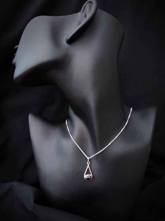 Sterling silver pendant with oval garnet