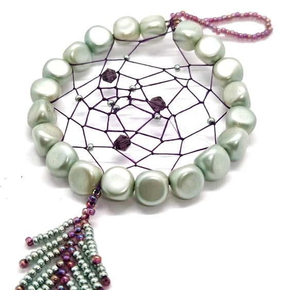 Small shimmering turquoise and purple beaded feather dream catcher