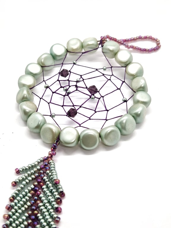 Small shimmering turquoise and purple beaded feather dream catcher