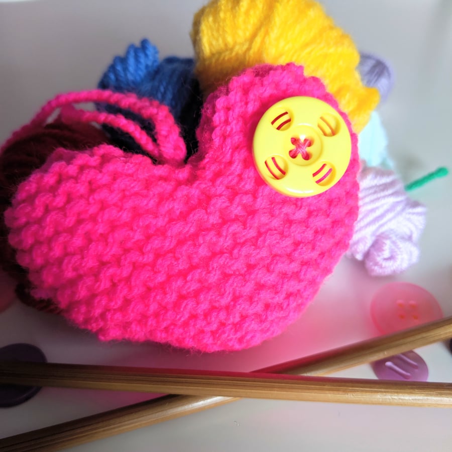 Hand-knitted neon pink button heart