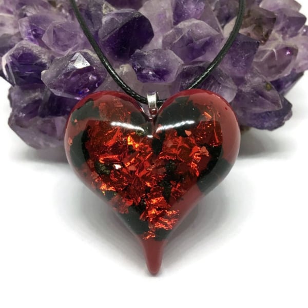 Red and black sparkly metallic puffy heart pendant with black cord necklace.
