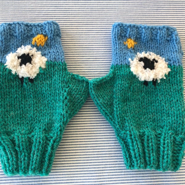 Hand knitted fingerless mittens with thumbs , sheep . Money to cat rescue .