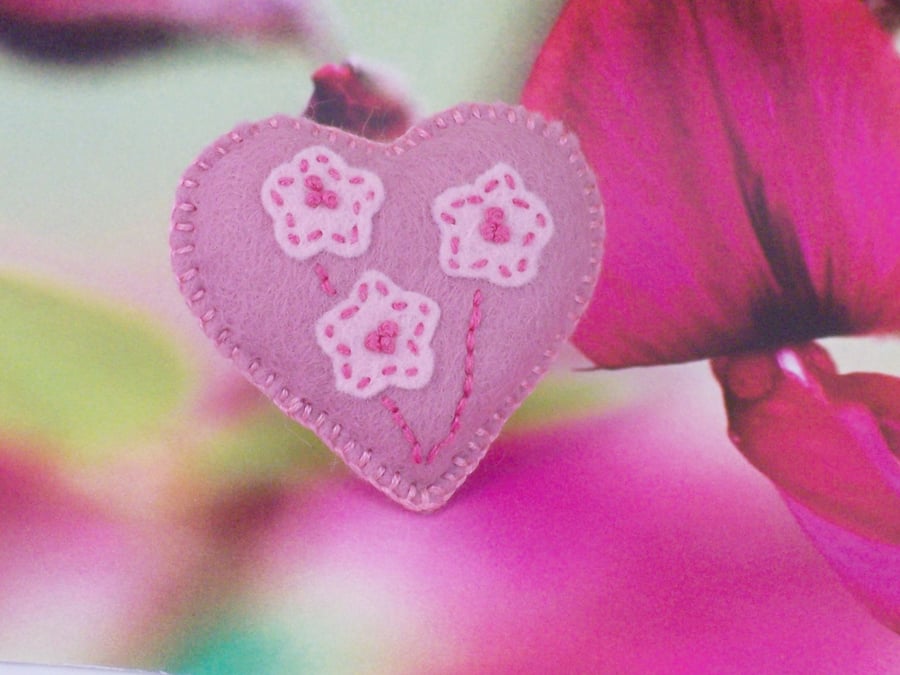 Pink hand stitched felt heart shaped brooch with embroidery