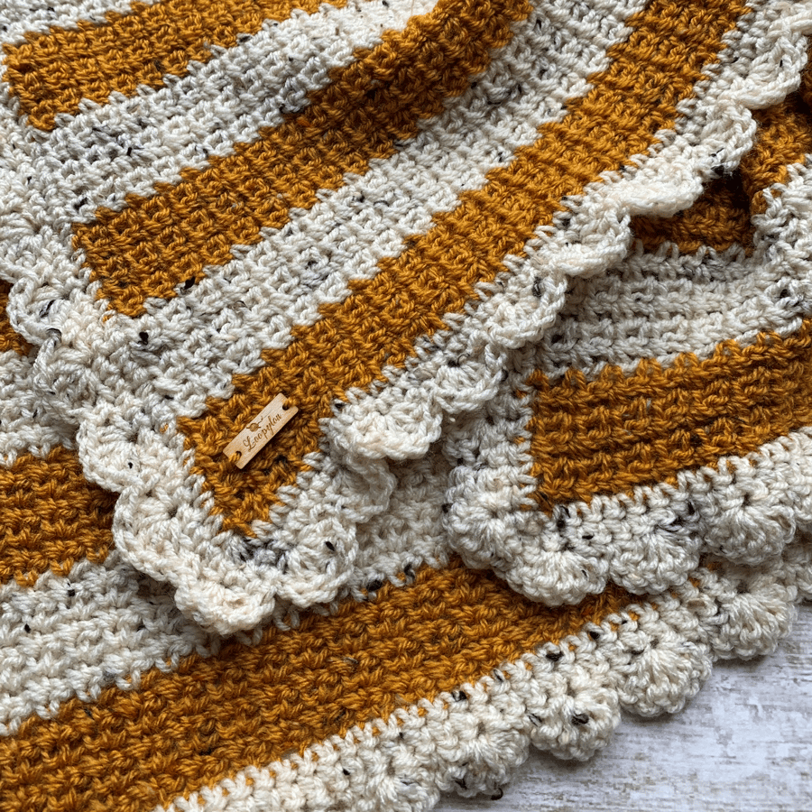 Ochre mustard and cream striped crochet blanket with shell border