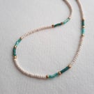 Glass beaded necklace, 'dash' design, cream, gold with green and aqua, 17 to 19"