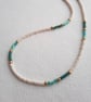 Glass beaded necklace, 'dash' design, cream, gold with green and aqua, 17 to 19"