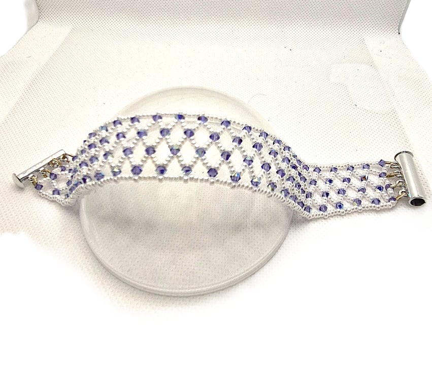 A seed bead netted bracelet with purple Swarovski crystals