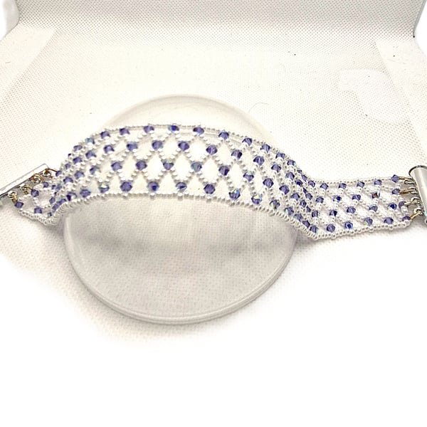 A seed bead netted bracelet with purple Swarovski crystals