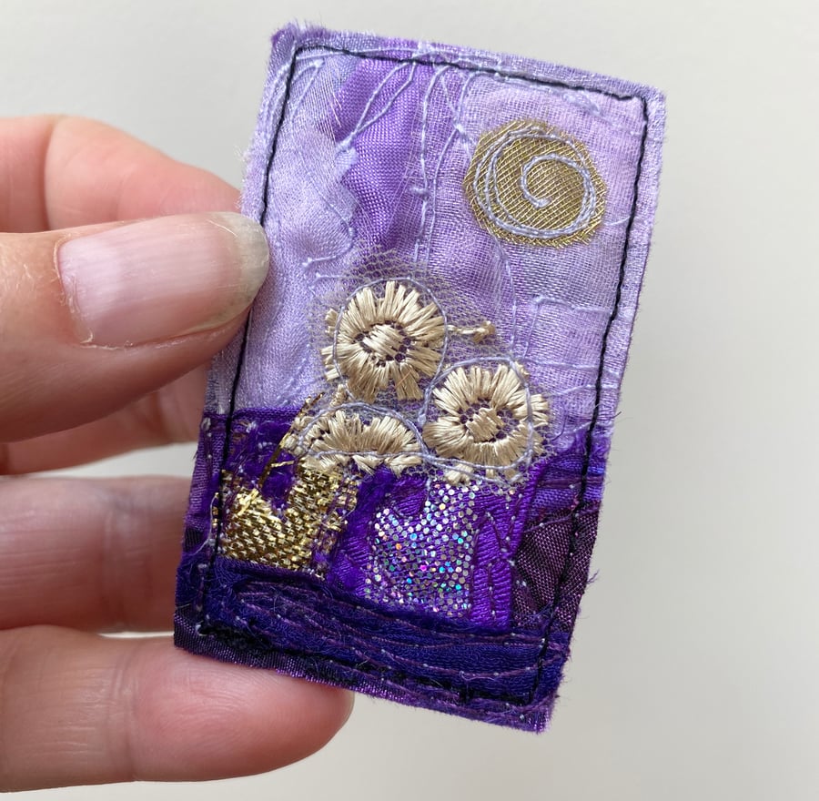 Embroidered up-cycled purple landscape brooch pin or badge. 