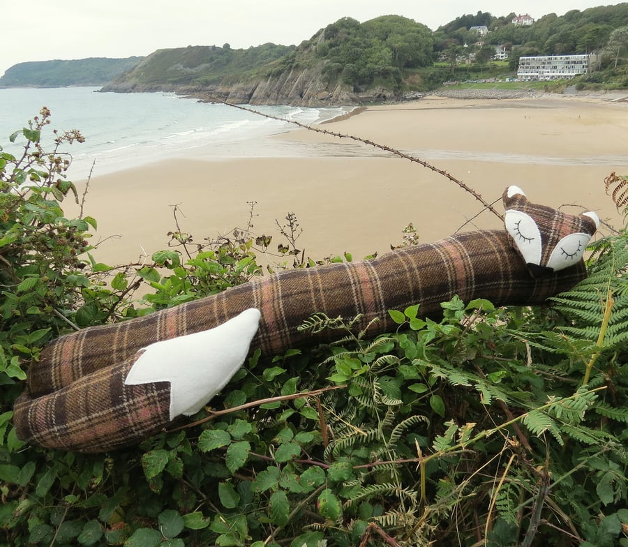 Long fox.  A tartan fox draught excluder. 