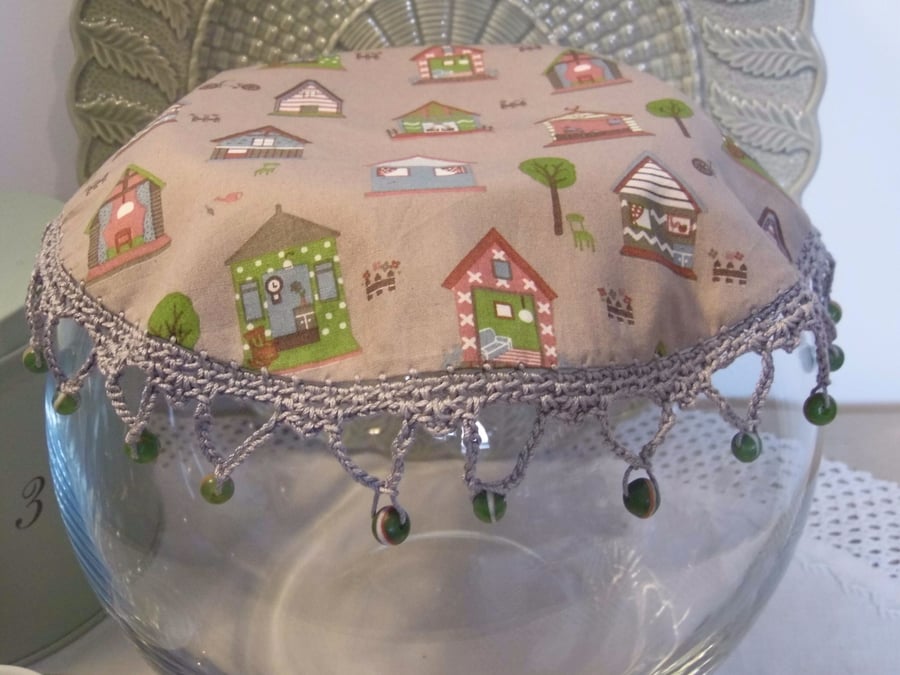 House print fabric jug cover, with crochet edging and glass beads.