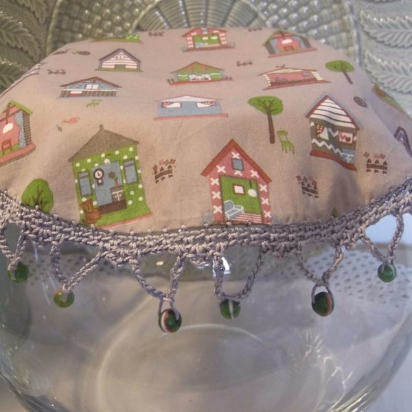 House print fabric jug cover, with crochet edging and glass beads.