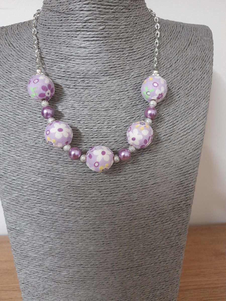 LAVENDER, PURPLE AND SILVER FLORAL FABRIC BEADED NECKLACE WITH FREE EARRINGS.