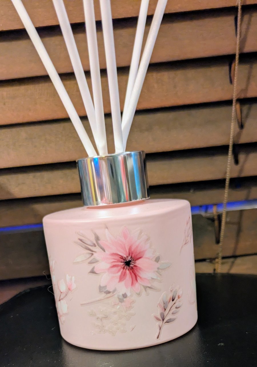 Pink glass floral diffuser bottle with white reed sticks 