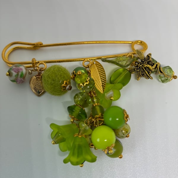 A very bright green kilt pin brooch