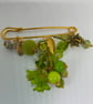 A very bright green kilt pin brooch