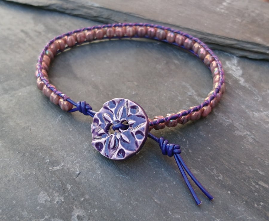 Purple leather and glass bead bracelet with ceramic flower button