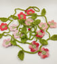 Crochet Flowers Garland in Pinks, Peach and Coral - Image 1