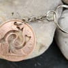 Pisces symbol cut from penny coin as bag charm or keyring