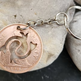 Pisces symbol cut from penny coin as bag charm or keyring