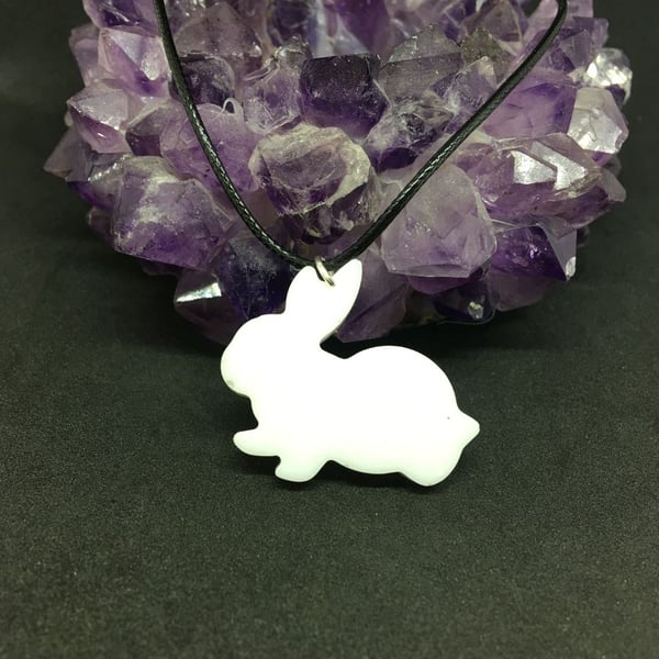 White rabbit pendant with a black cord chain.