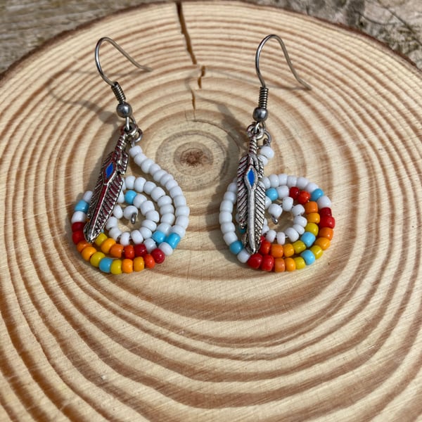 Boho style beaded earrings with a feather charm 