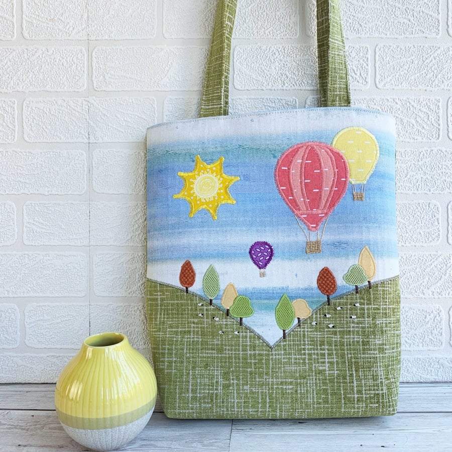Tote bag with hot air balloons flying over hills