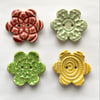 Set of four flower shaped ceramic handmade buttons