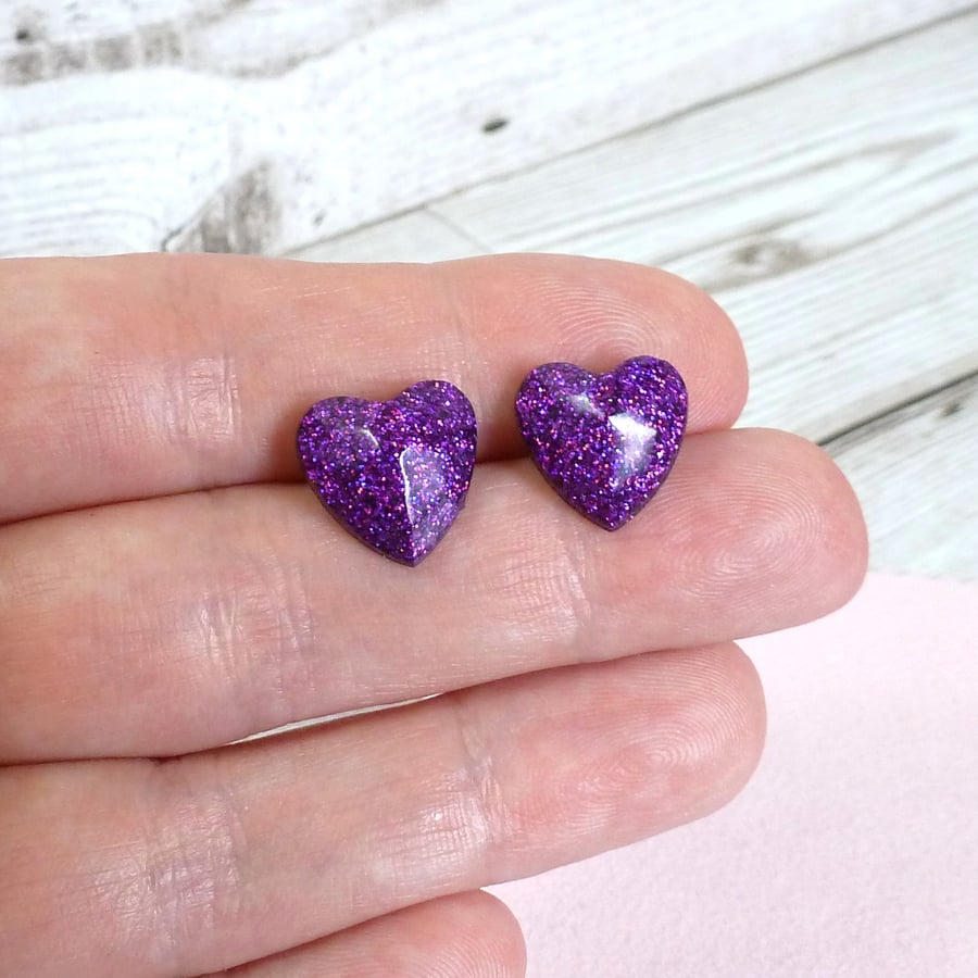 Purple heart studs. Bright and colourful purple glitter heart-shaped earrings