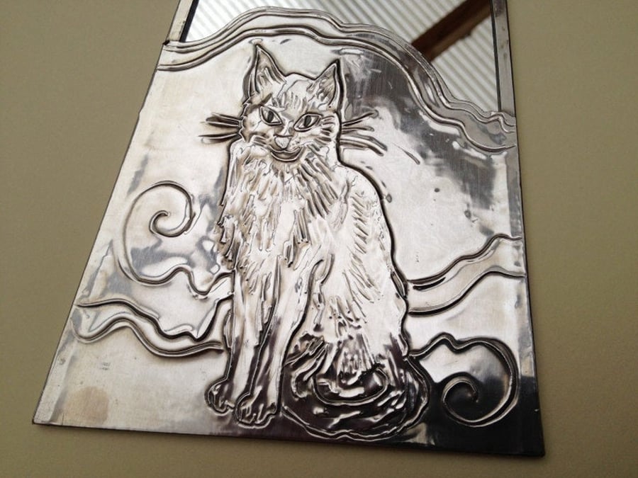 Cat mirror, pewter edged mirror with a cat design.