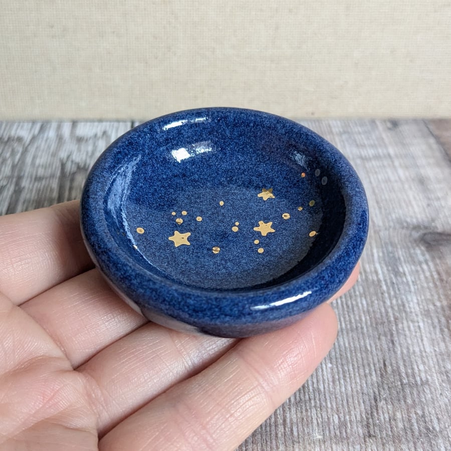 Very small blue ceramic ring dish with gold stars