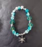 Elasticated winter beaded bracelet with crystal chip and snowflake charm - Image 1