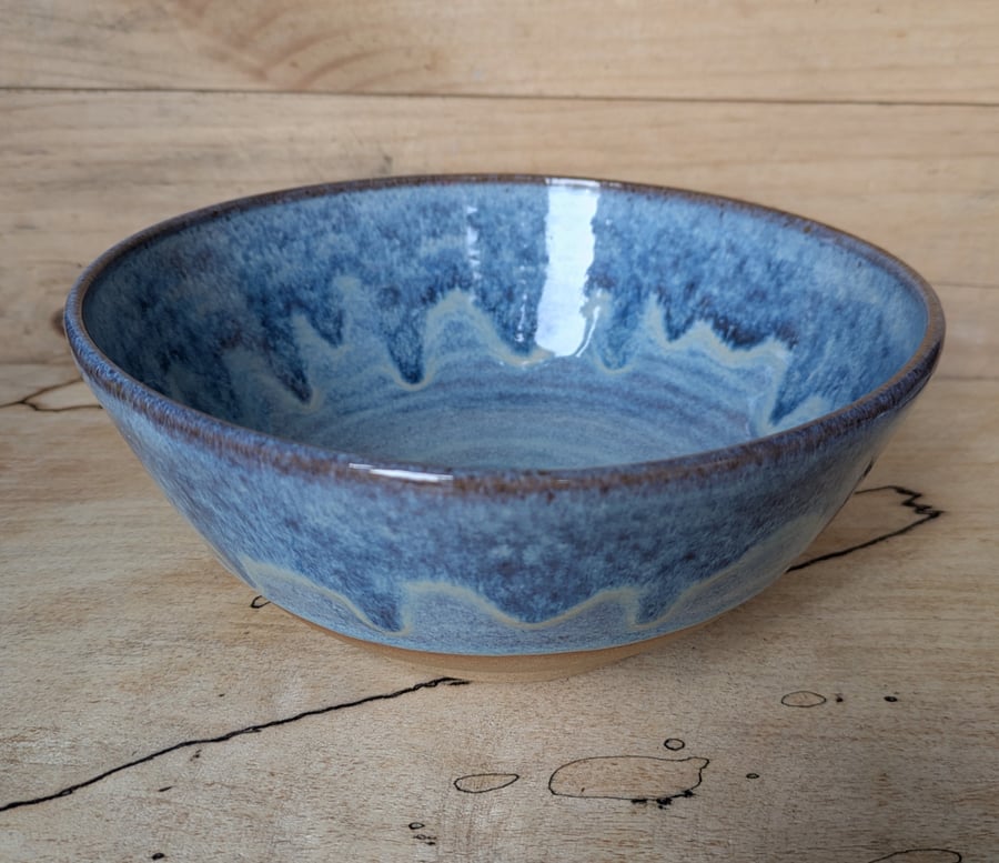 Medium to large sized pale blue wavy toasted bowl