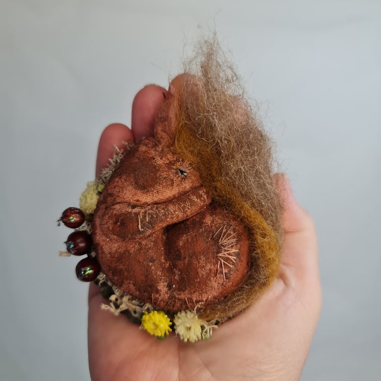 Handmade sleepy squirrel soft sculpture textile art.
