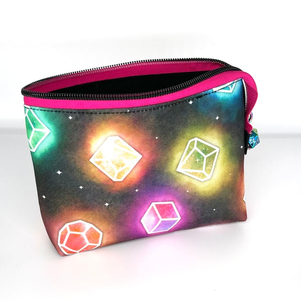 Cosmetic bag with DnD dice print, pink zipper and D20 zipper pull.