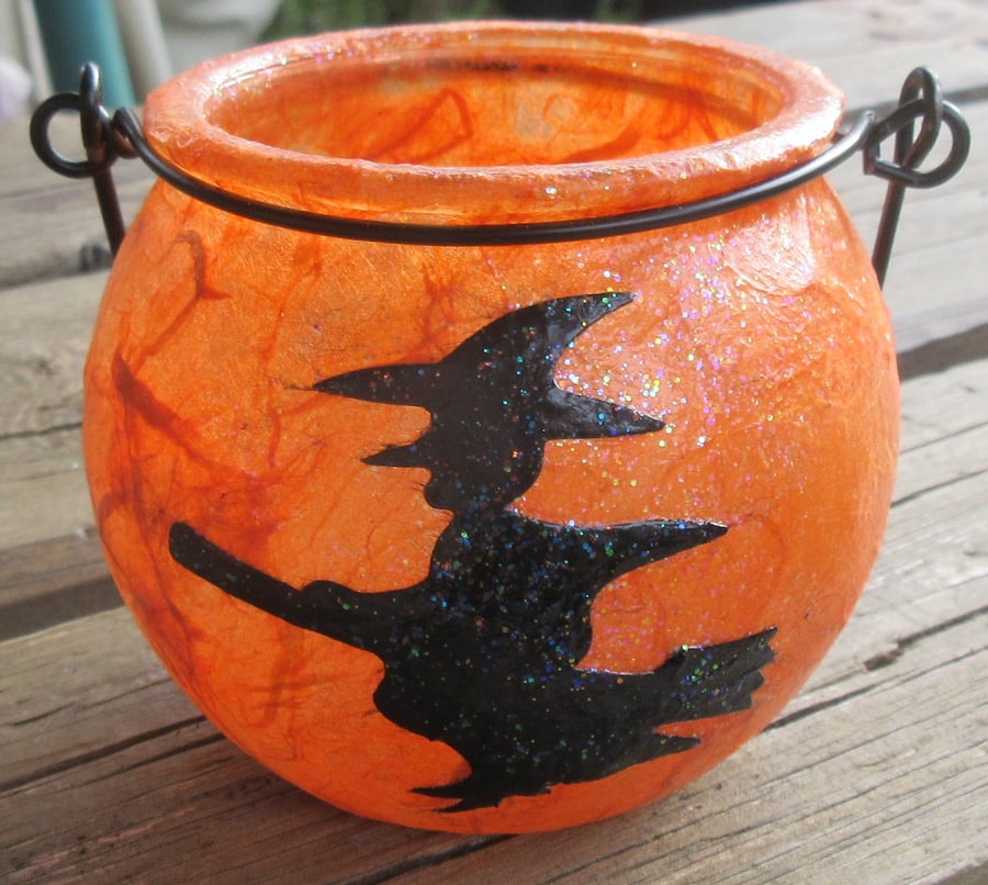 Cauldron shaped tea light holder witch on broomstick flying left 