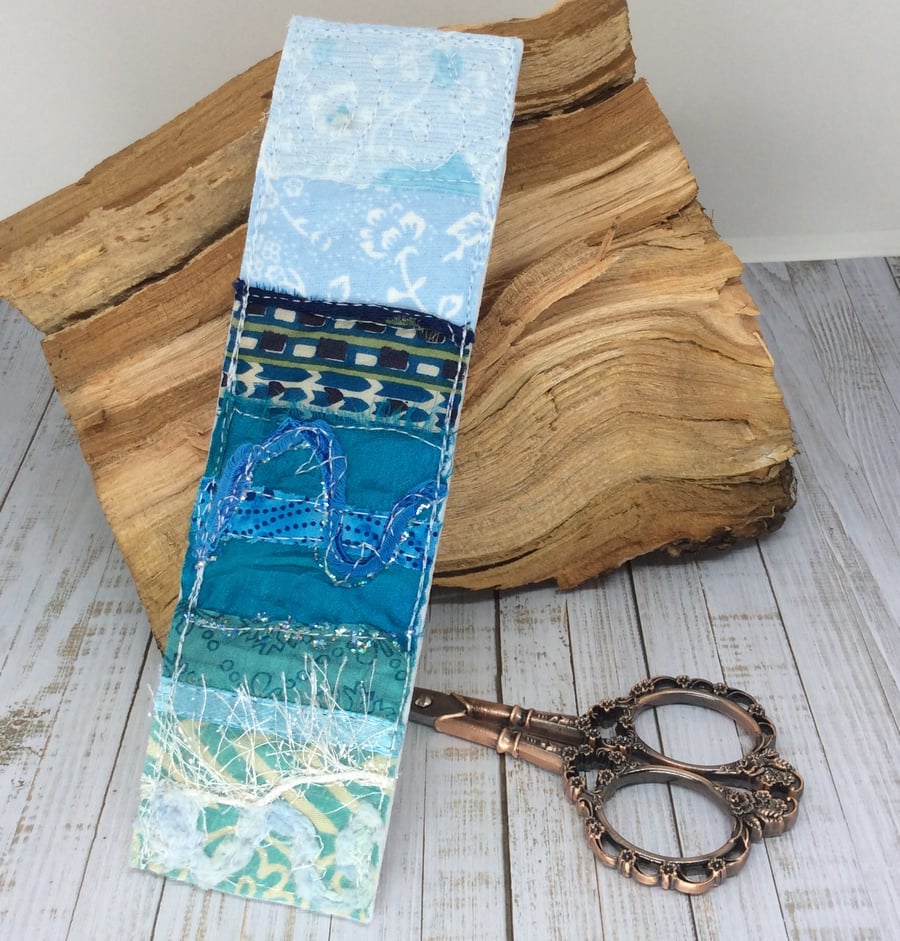 Embroidered up-cycled seascape bookmark.