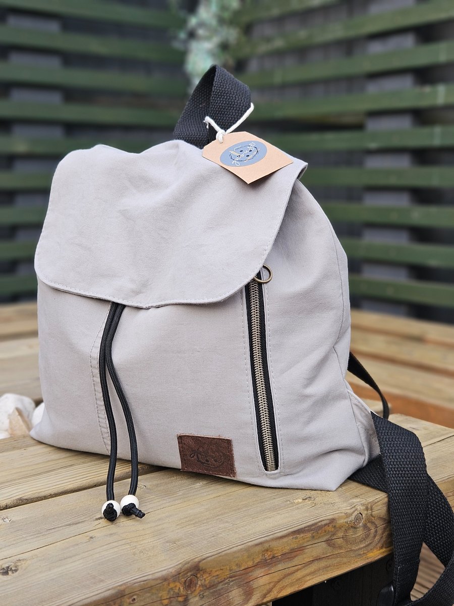 Stylish and compact backpack in a light colour.