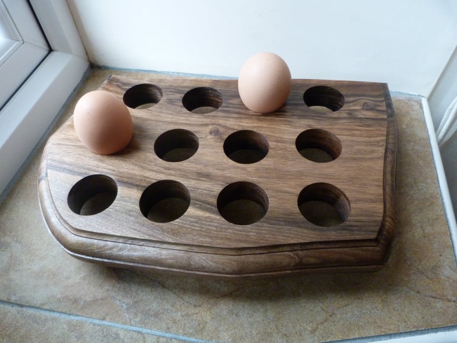 WOODEN  EGG  STAND, FOR TWELVE EGGS IN WALNUT WITH MACHINE CONTORED EDGES