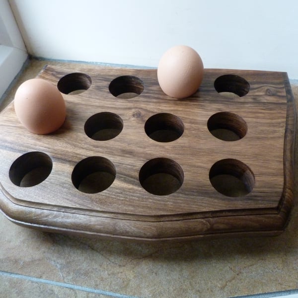 WOODEN  EGG  STAND, FOR TWELVE EGGS IN WALNUT WITH MACHINE CONTORED EDGES