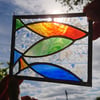 Stained glass blue, red, green fish hanging panel in copperfoil and lead 