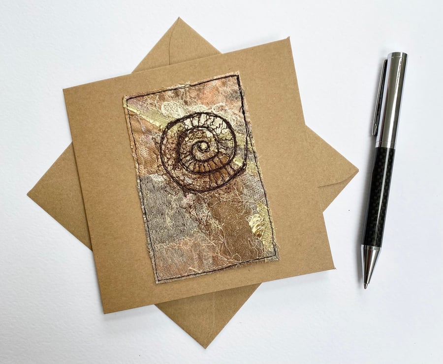 Up-cycled embroidered fossil ammonite card. 