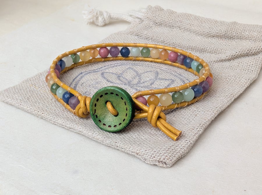 Pastel rainbow gemstone bracelet with gold leather and green wooden button