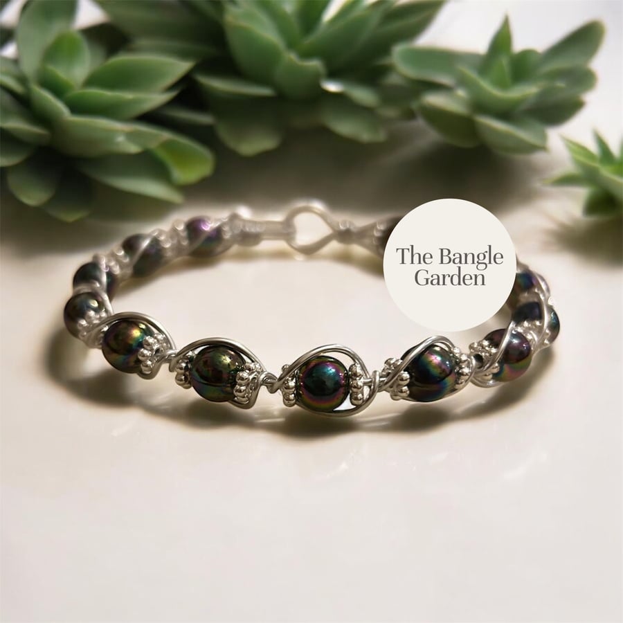 Handmade wire wrapped bangle with deep black green purple variegated beads 