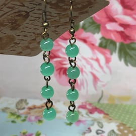 Green glass cats eye earrings